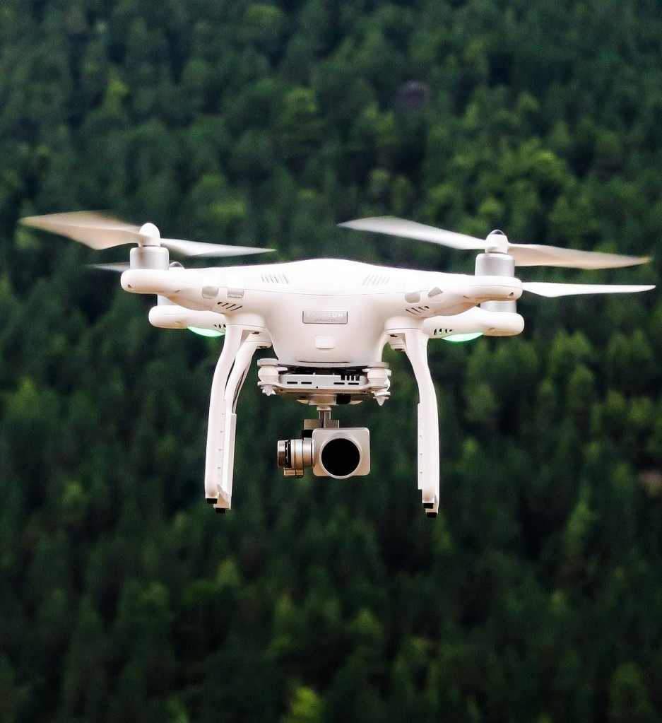 Photo of a drone over a forest.